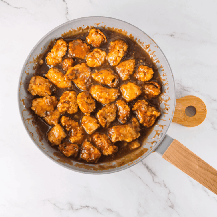 Mixing cornstarch and water to create smooth slurry for thickening sauce