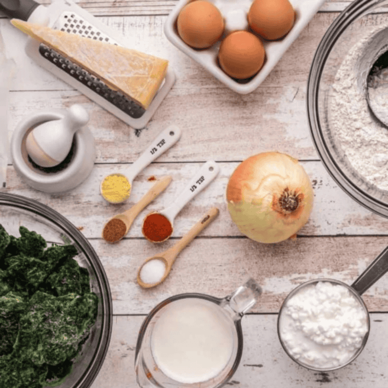 Ingredients needed for Easy Ina Garten Spinach Quiche Recipe on kitchen table.
