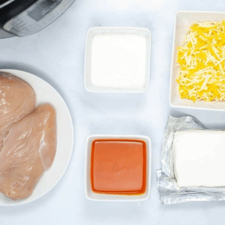 Ingredients needed for Easy Instant Pot Buffalo Chicken Dip on kitchen table.