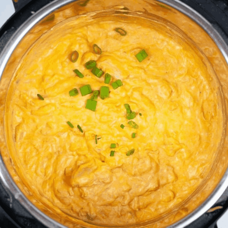 Easy Instant Pot Buffalo Chicken Dip served hot in a bowl with tortilla chips
