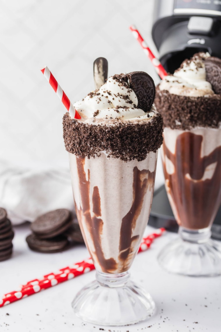 Ninja Creami chocolate milkshake topped with whipped cream and a chocolate drizzle