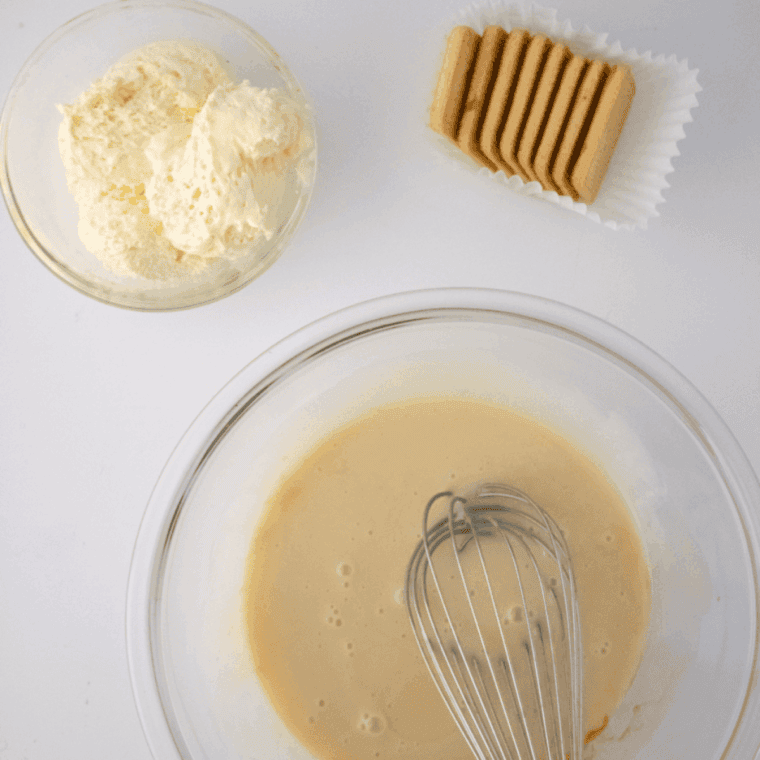 Whisking instant vanilla pudding mix with whole milk in a large bowl until smooth