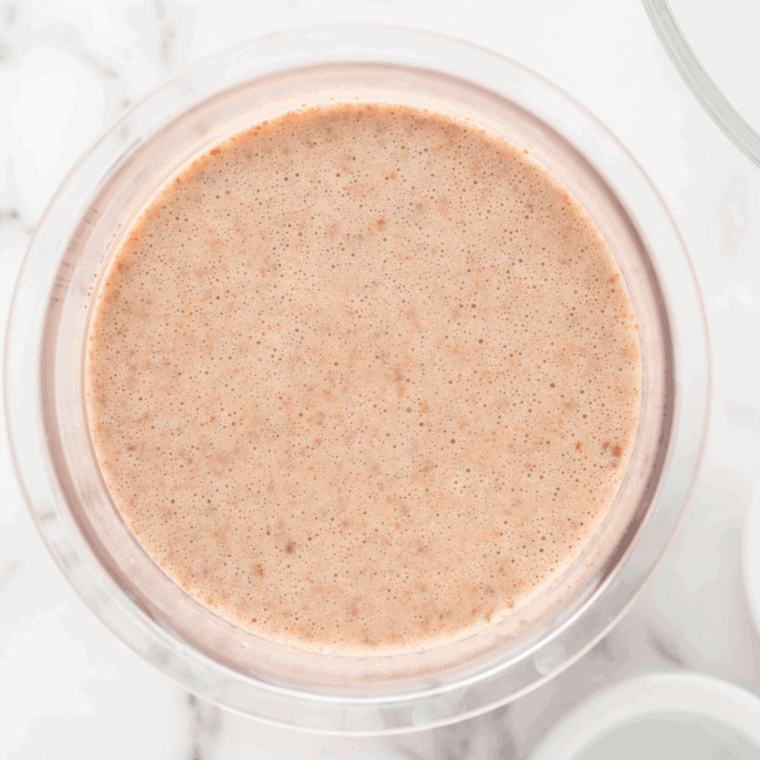 Melting cookie butter in the microwave, then folding into milk and heavy cream mixture