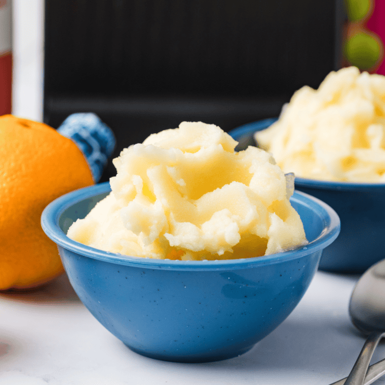 Bowl of Ninja Creami lemon sorbet garnished with fresh lemon zest