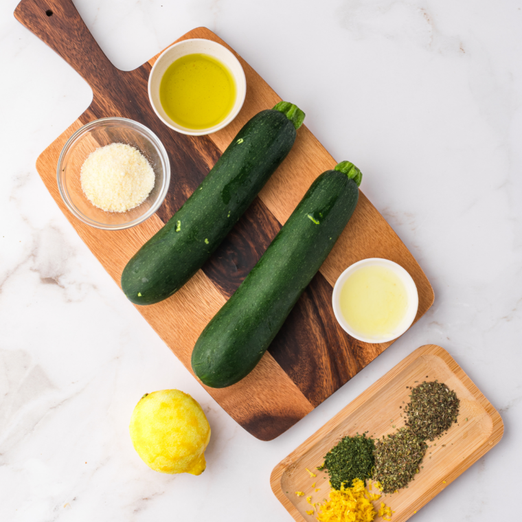 Ingredients needed for Ninja Foodi Grill Zucchini with Perfect Grill Marks on kitchen table.