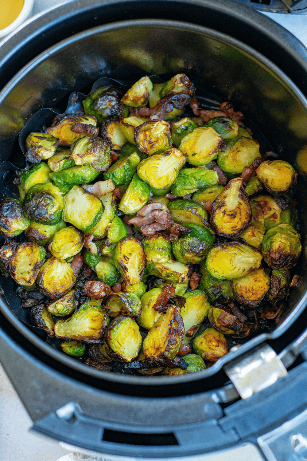 Cooked Bonefish Brussel Sprouts in the air fryer basket. Perfectly cooked.