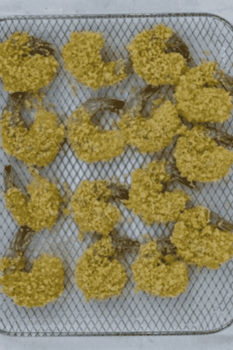 Shrimp being coated in seasoned flour mixture and prepped for air frying, with air fryer preheating to 400&deg;F for crispy cooking.