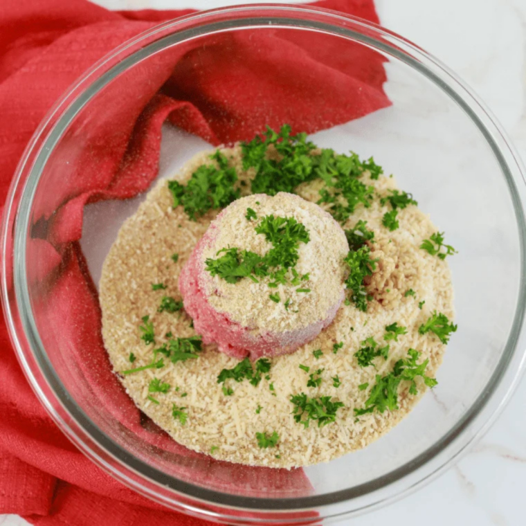 Breadcrumbs and milk stirred together in a glass bowl to make a panade