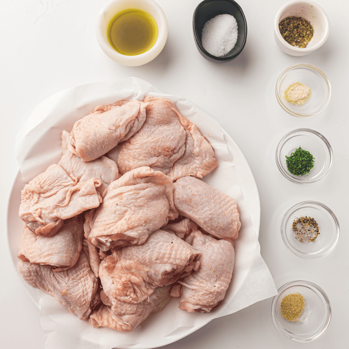 Ingredients needed for How To Cook Frozen Boneless Skinless Chicken Thighs in Air Fryer (No Thawing!) on kitchen table.