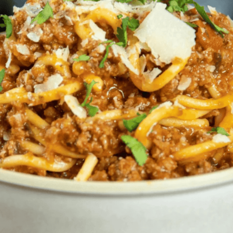 Close-up of spaghetti and meatballs served from Ninja Speedi with tomato sauce and fresh herbs