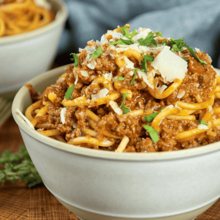 Bowl of spaghetti and meatballs made in Ninja Speedi with rich marinara sauce and parmesan cheese