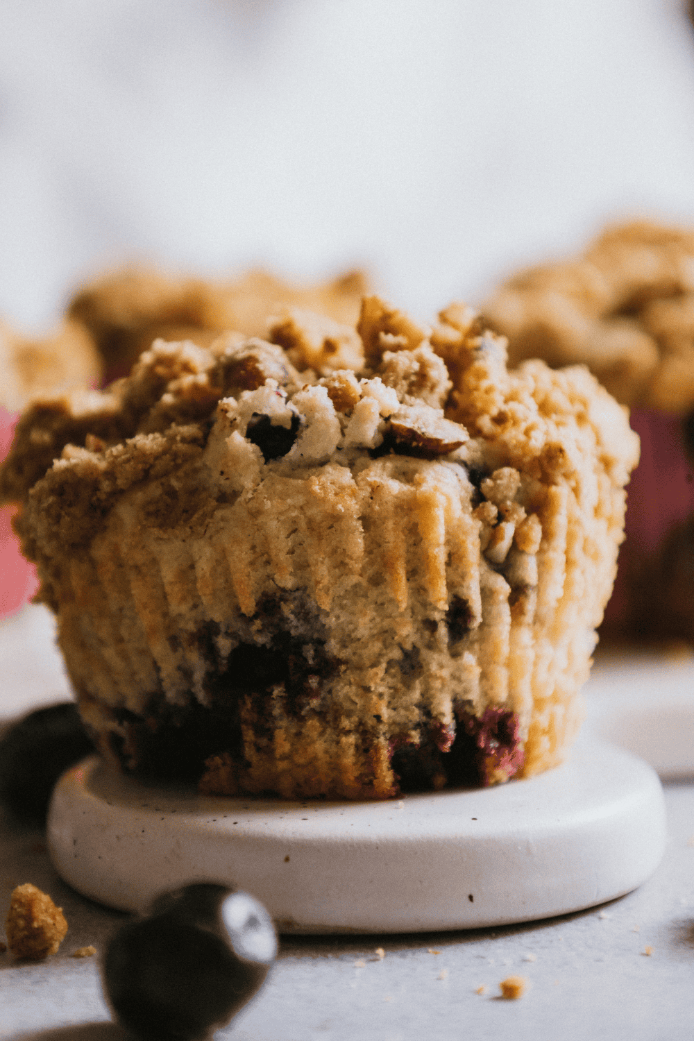 Freshly baked Ninja Woodfire Blueberry Muffins in a pan, golden brown with blueberries peeking through.