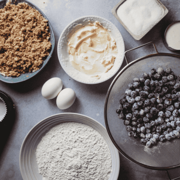 Ingredients needed for Ninja Woodfire Blueberry Muffins on kitchen table.