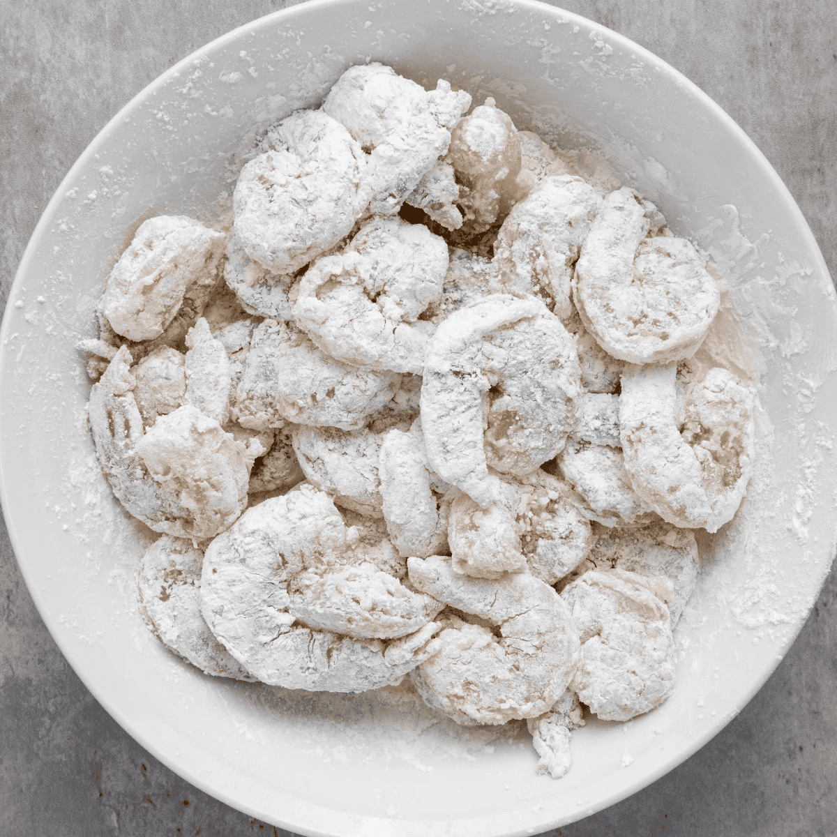 Raw shrimp tossed in seasoned cornstarch coating for salt and pepper shrimp