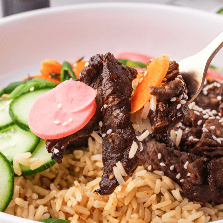 Air Fryer Trader Joe's Bool Kogi served with rice and saut&eacute;ed vegetables on a white plate