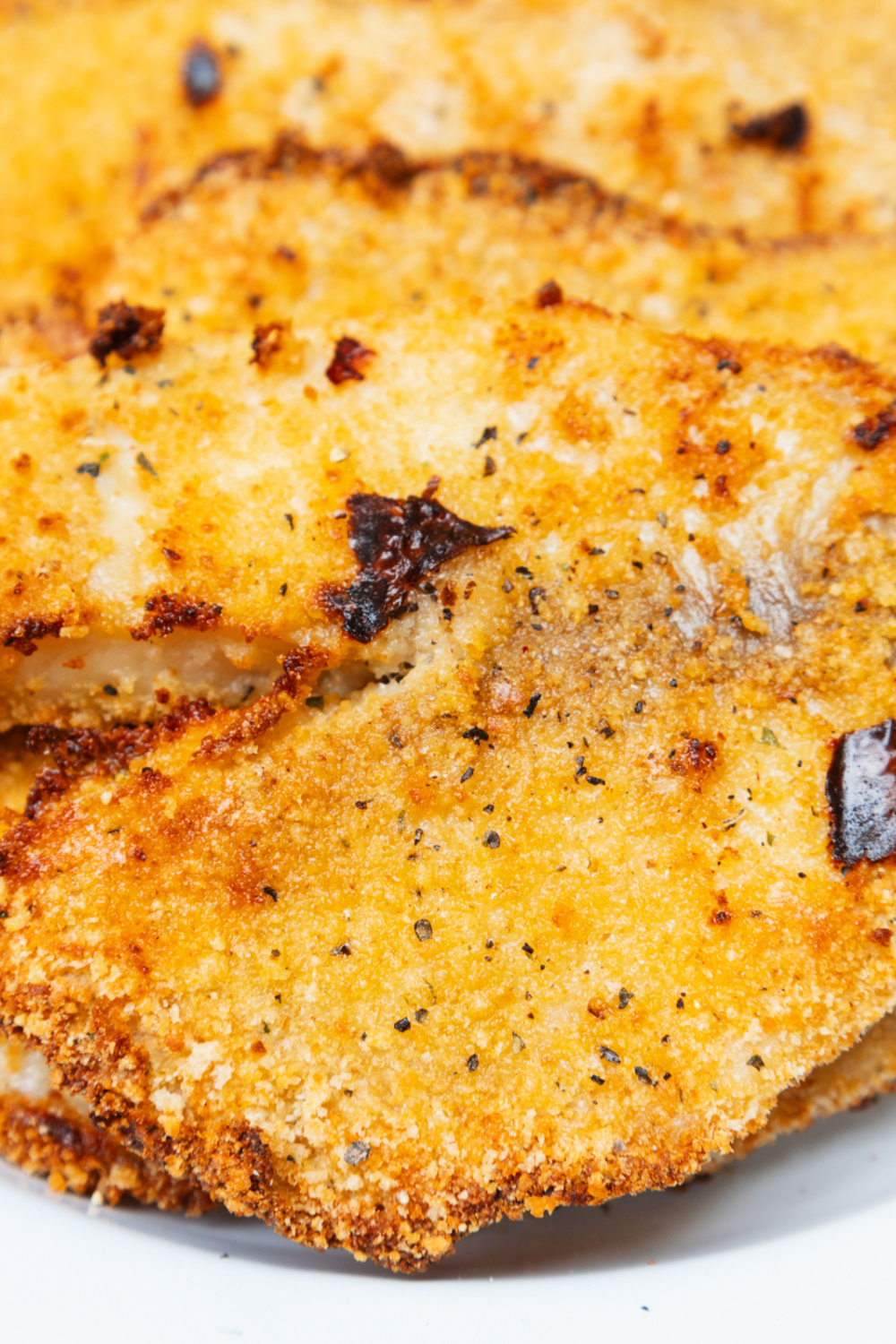 Plated Blackstone tilapia garnished with fresh herbs, ready to serve hot.
