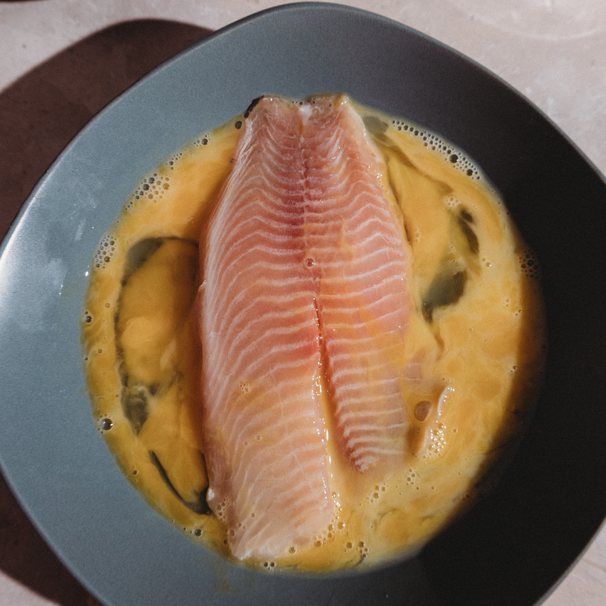 Blackstone griddle heating to 350&ndash;400&deg;F for searing tilapia fillets evenly.