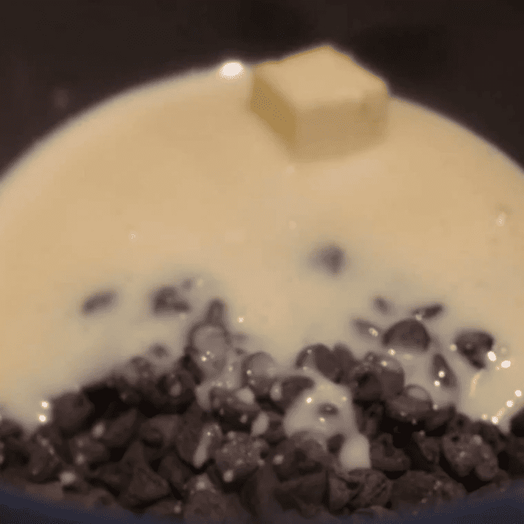 Stirring vanilla extract and salt into a smooth melted chocolate fudge base