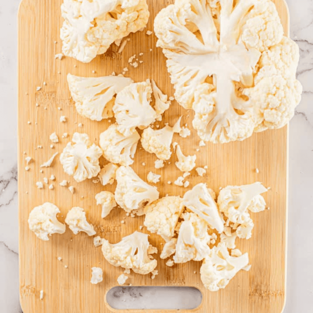 Ingredients needed for Ina Garten's Garlic-Roasted Cauliflower on kitchen table.