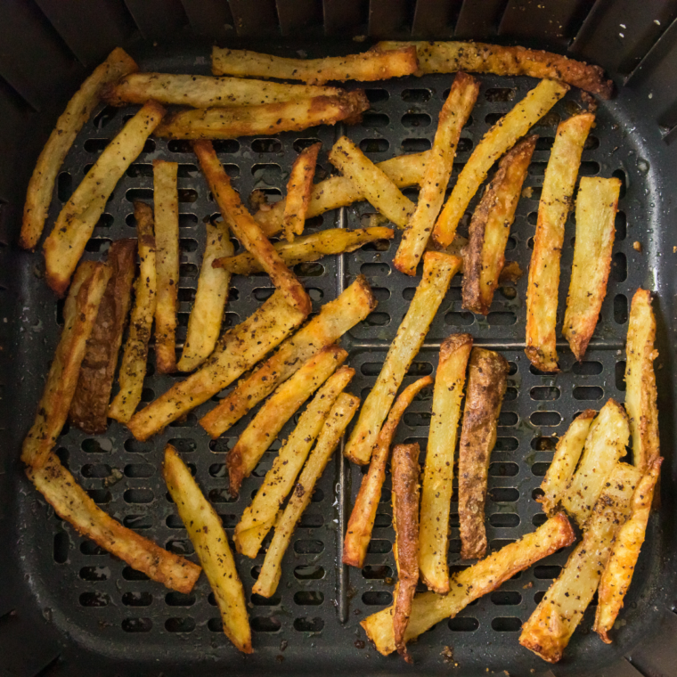 Hot steak fries tossed with blackened seasoning in a large mixing bowl