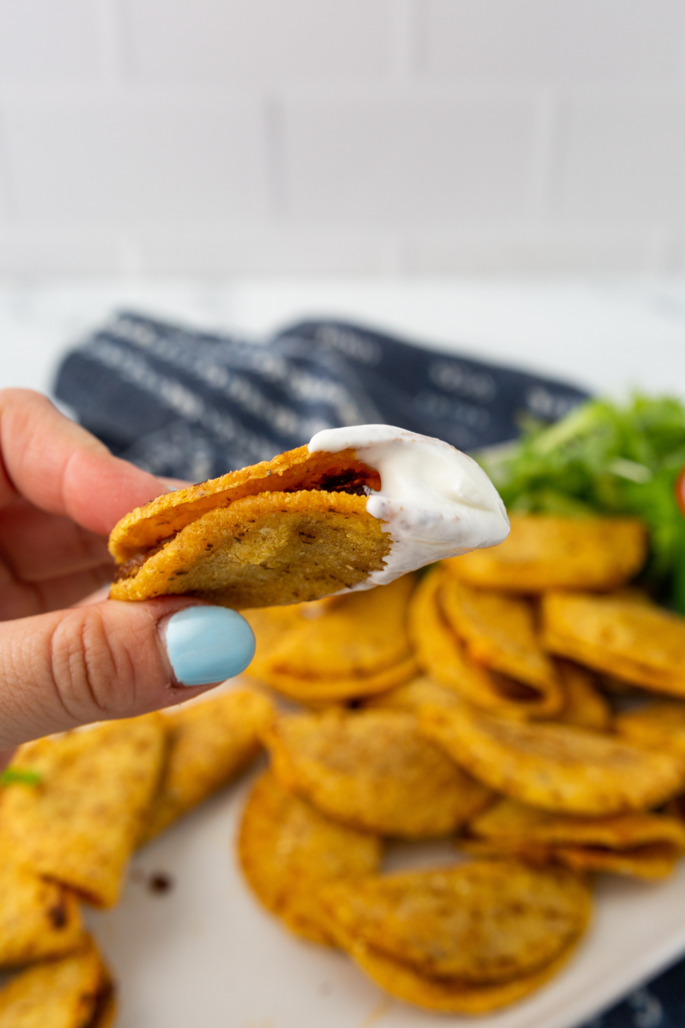 air fryer Trader Joe&rsquo;s mini chicken tacos crispy golden shell served on plate with dip