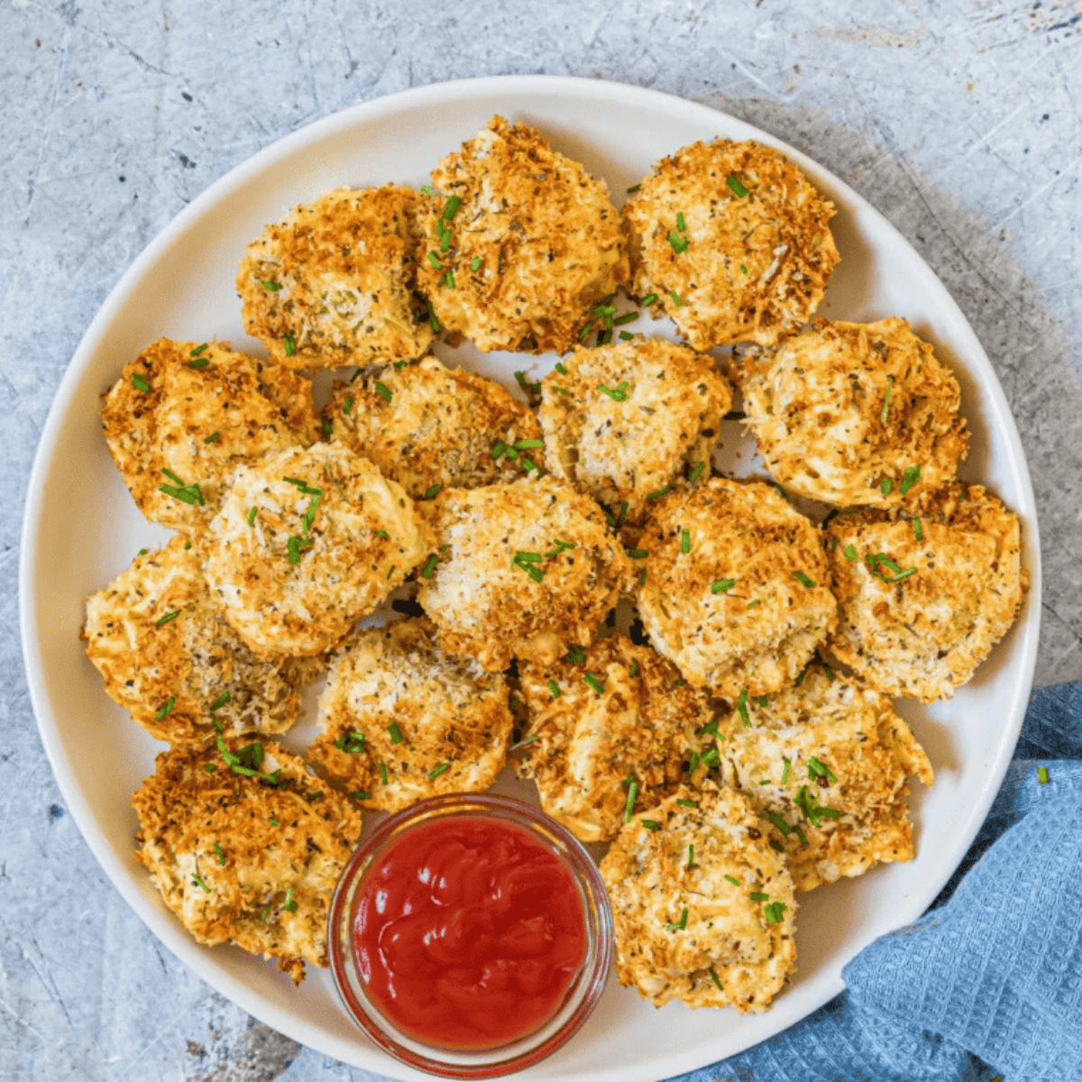 crispy tortellini pasta bites served on a platter with dipping sauce