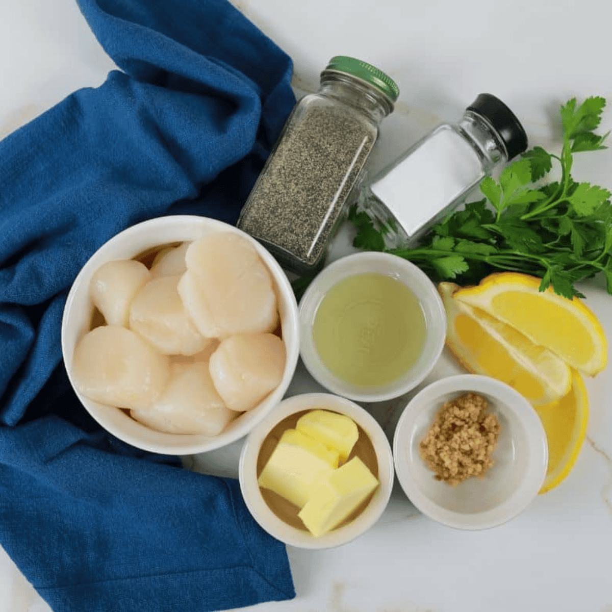 Ingredients needed for Easy Air Fryer Frozen Scallops Recipe on kitchen table.