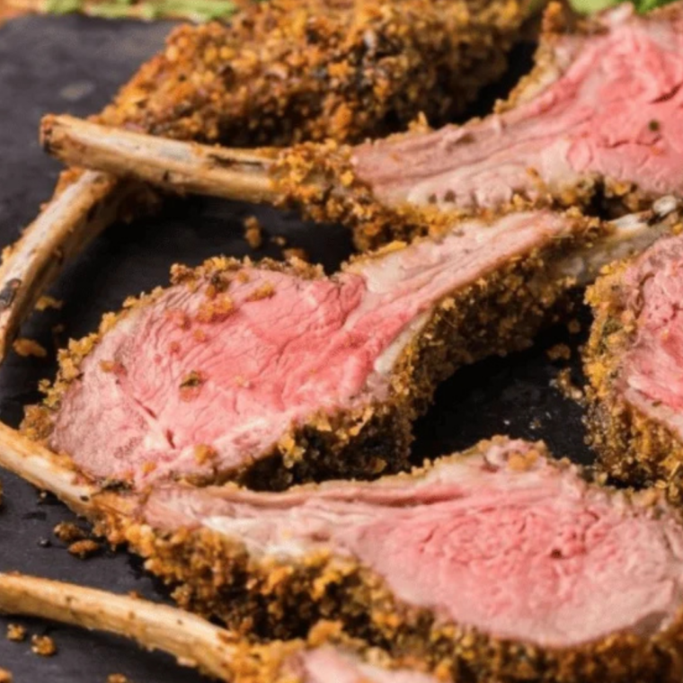 Air fryer lamb cutlets served on a black plate garnished with fresh rosemary