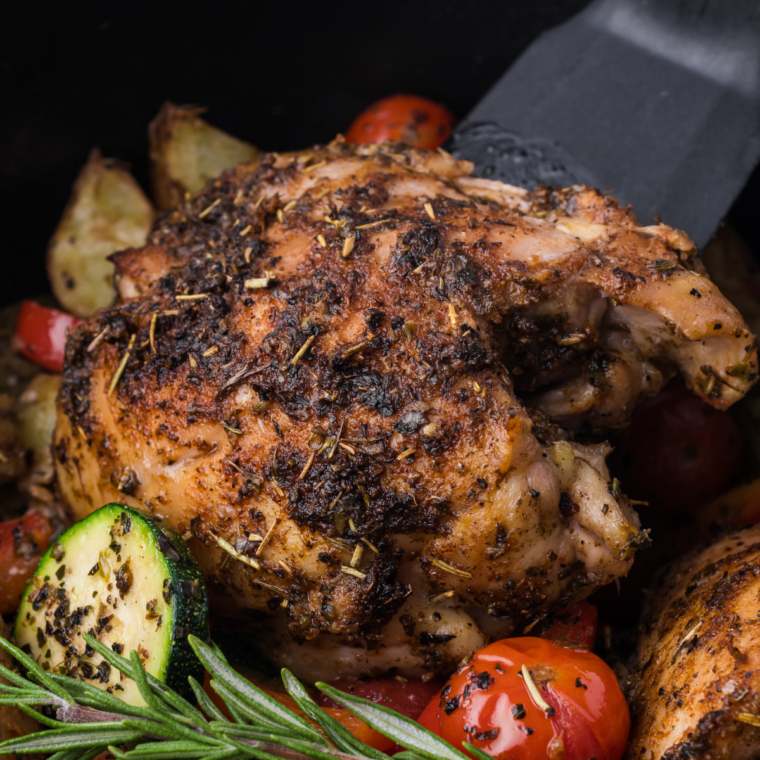 Instant-read thermometer inserted into an air fryer chicken thigh, showing it reached 165°F