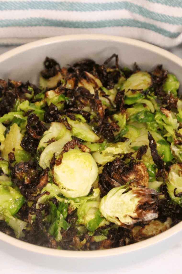 Crispy Blackstone Brussels sprouts with charred edges served as a quick griddle side dish.