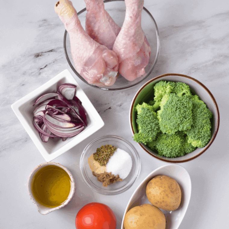 Ingredients needed for Easy Air Fryer Chicken Drumsticks with Vegetables on kitchen table.