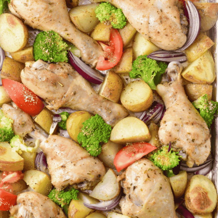 Cooked Easy Air Fryer Chicken Drumsticks with Vegetables in air fryer basket.