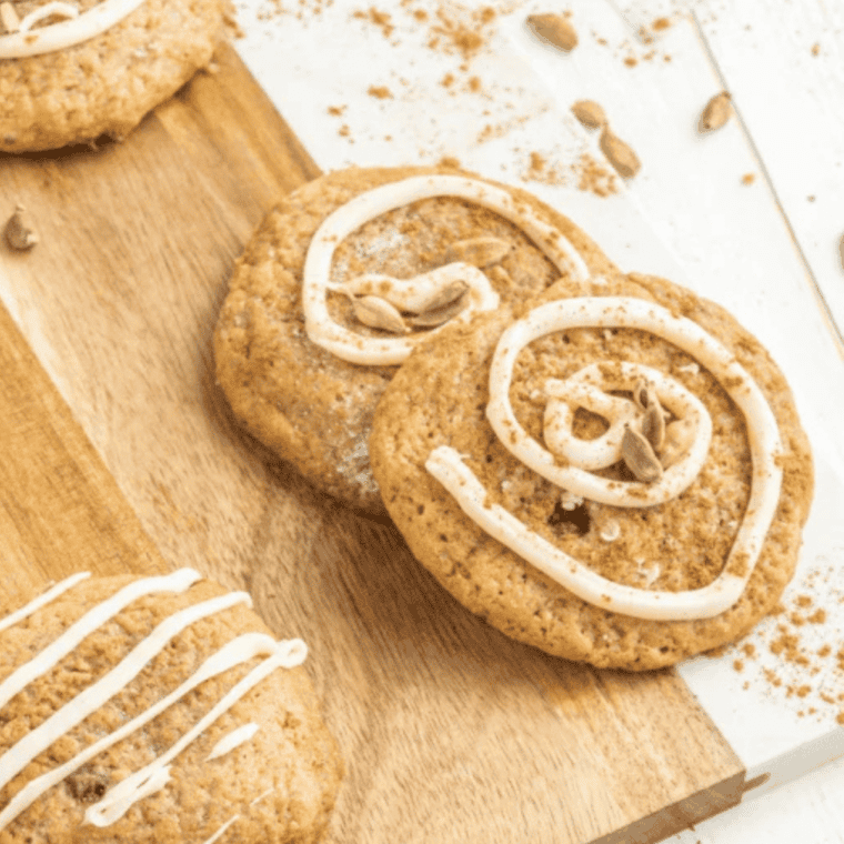 Drizzling glaze and sprinkling sugar over cooled chai sugar cookies.