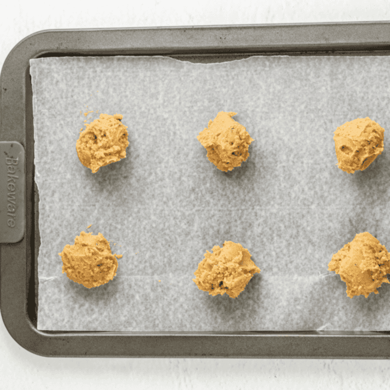 Preheating oven and lining baking sheets with parchment paper.