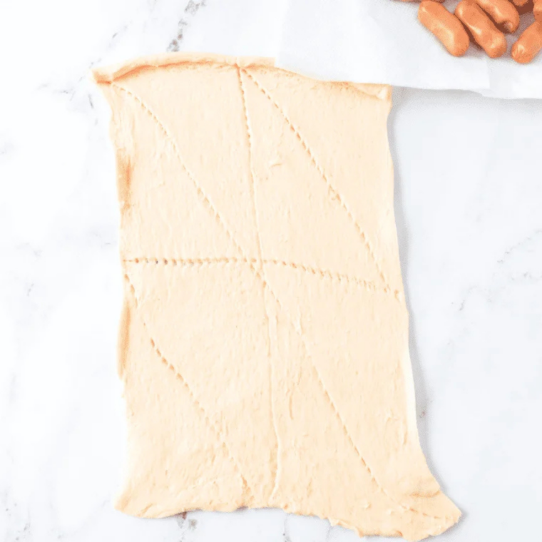Crescent roll dough coming to room temperature on a floured surface