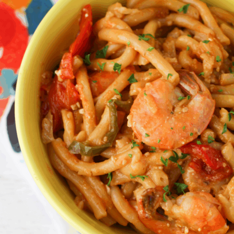 Close-up of Cajun Jambalaya Pasta with spicy shrimp, chicken, and peppers in a red cream sauce.