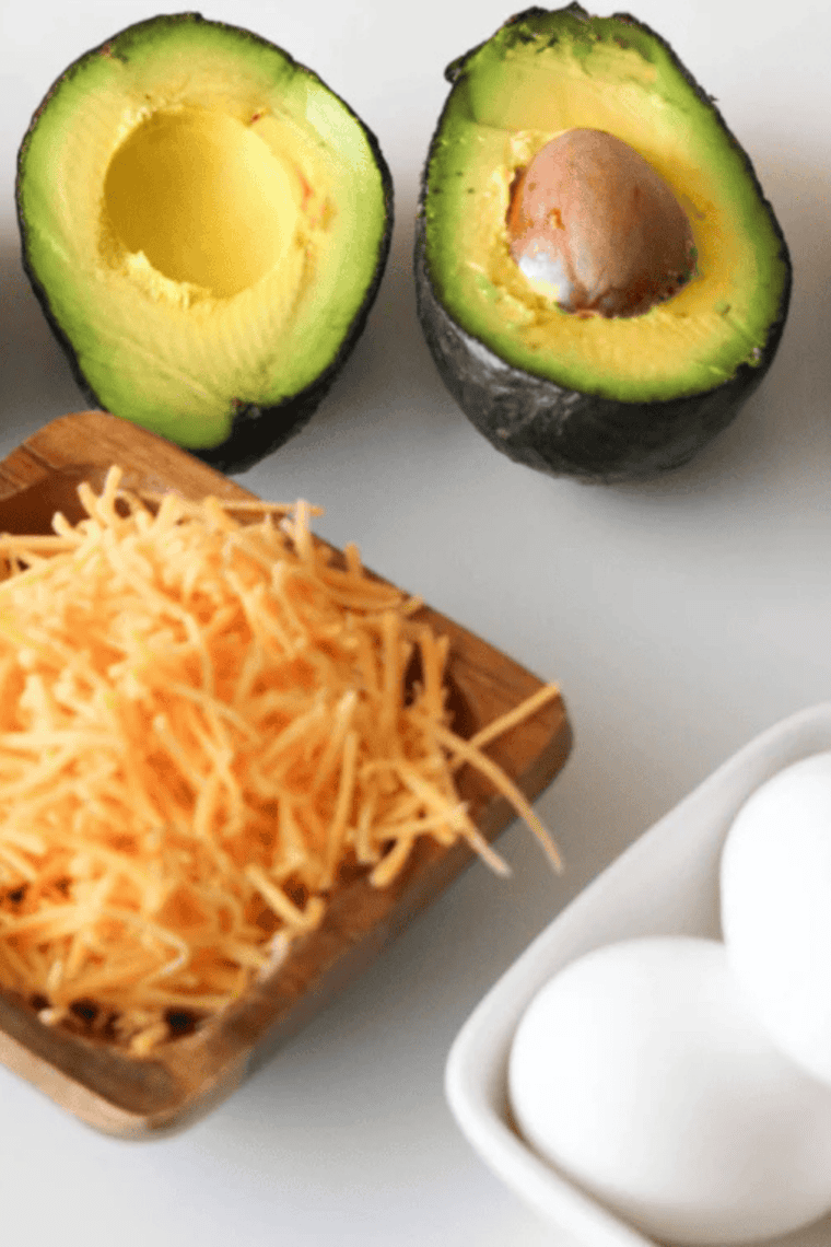 Ingredients needed for Easy Air Fryer Stuffed Avocado Recipe on kitchen table.