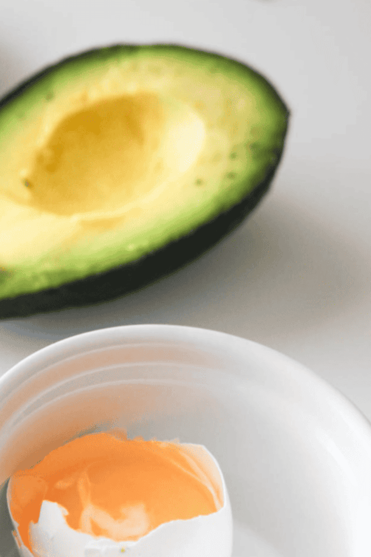 Halved avocado with the pit removed, ready to be stuffed with flavorful ingredients.