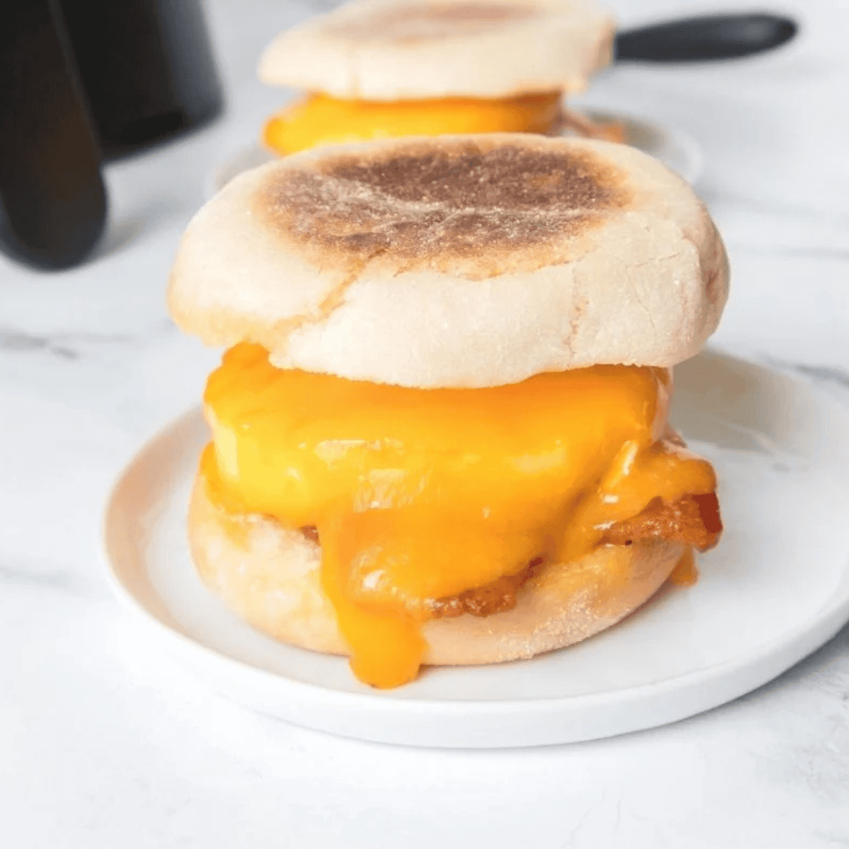 Spreading copycat McDonald's breakfast sauce on a toasted breakfast bagel.