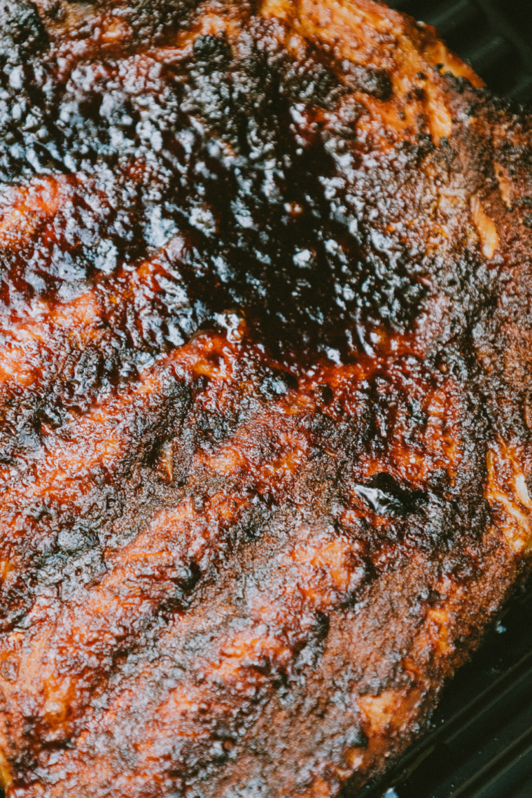 Checking ribs for doneness at 195&ndash;203&deg;F and letting them rest on a cutting board before slicing for juicy, tender results