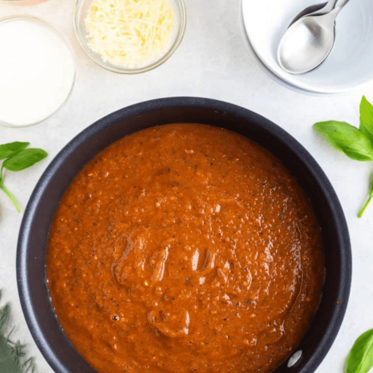 Roasted tomatoes, onion, and garlic in an air fryer basket, ready to blend into tomato soup