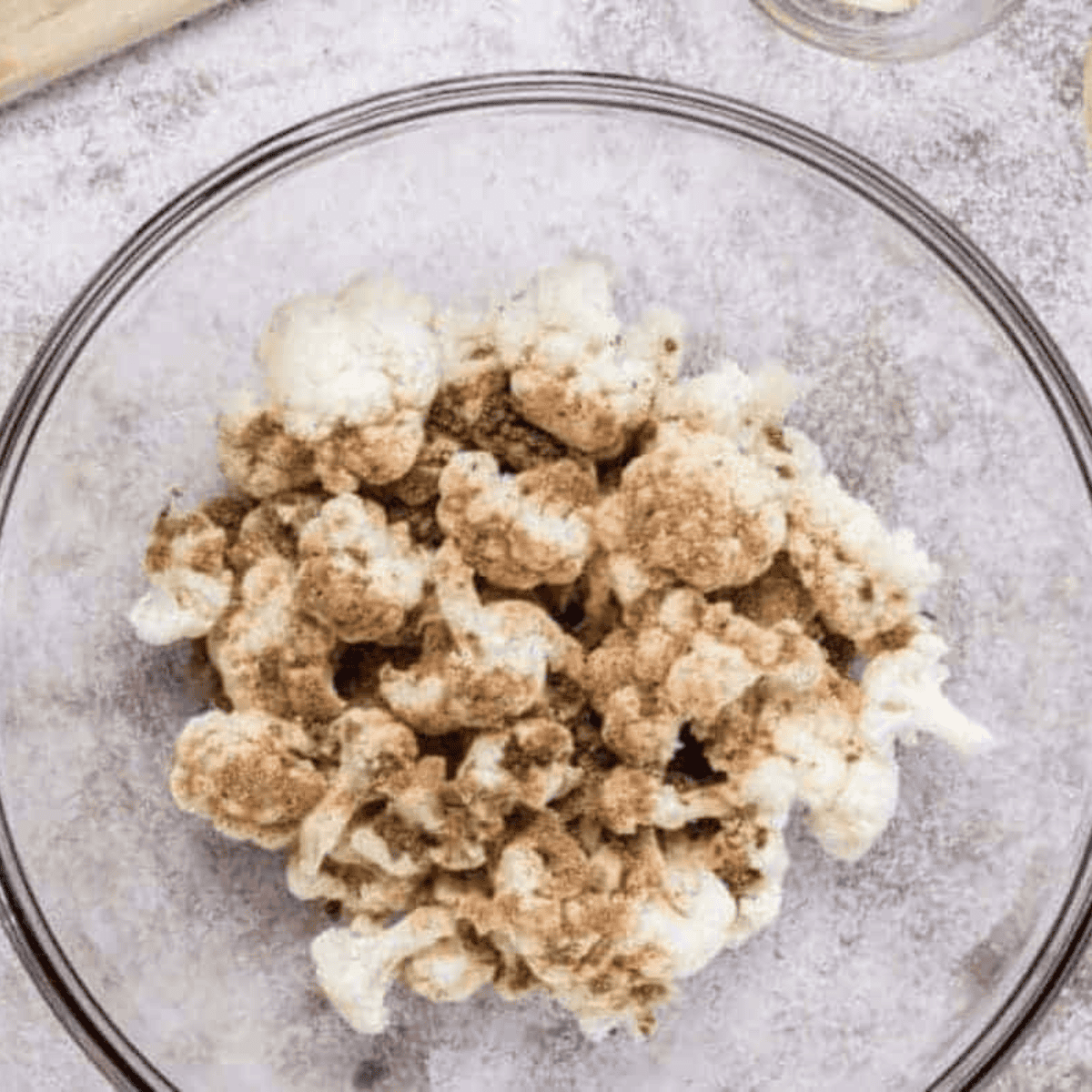 Mixing bowl with flour, cornstarch, milk, and seasonings whisked into smooth batter.