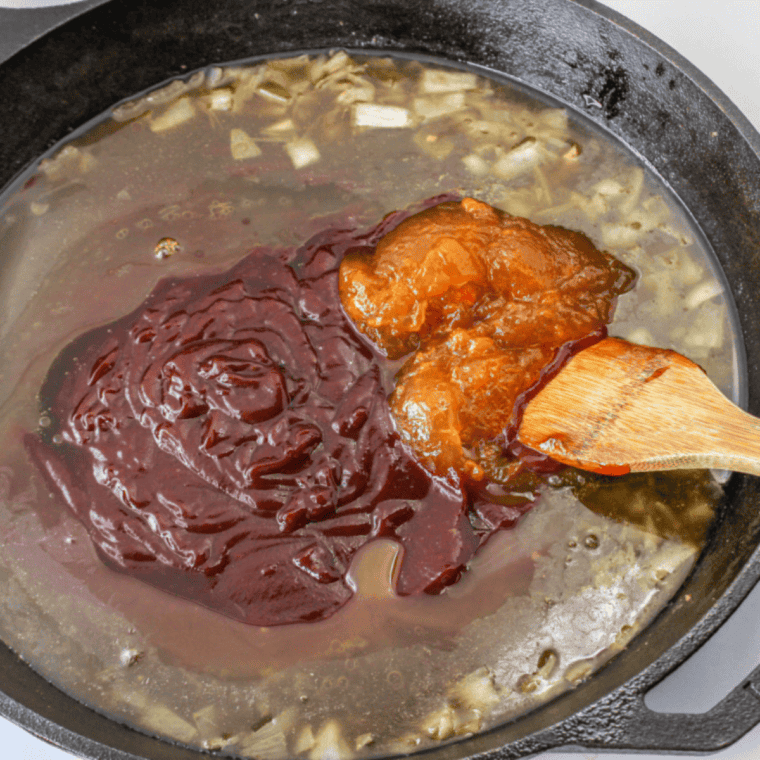 Mixing a smooth peach glaze with peaches, honey, mustard, garlic, salt, and pepper in a bowl.