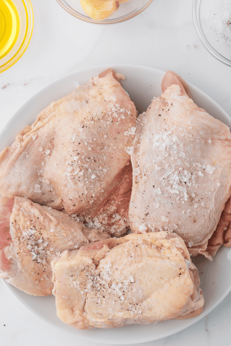 Chicken thighs rubbed with olive oil and seasoned with spices.