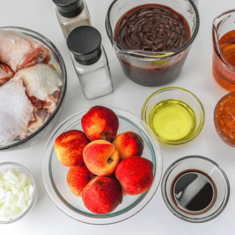 Ingredients needed for The Best Whiskey Peach BBQ Sauce Recipe on kitchen table.
