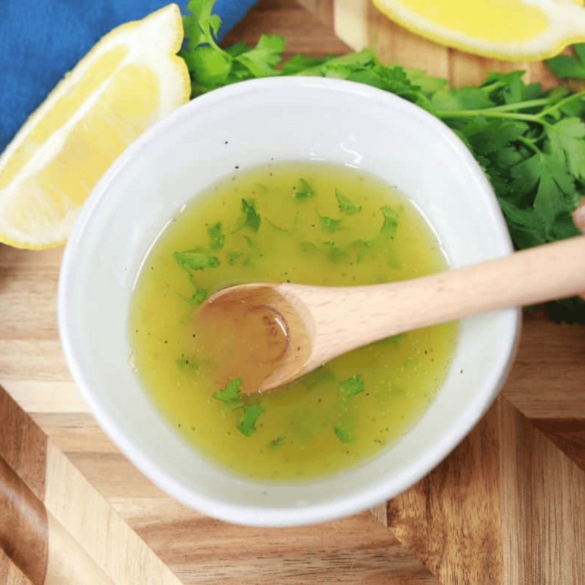 Gently tossing scallops in a bowl with olive oil, garlic powder, and sea salt for even seasoning
