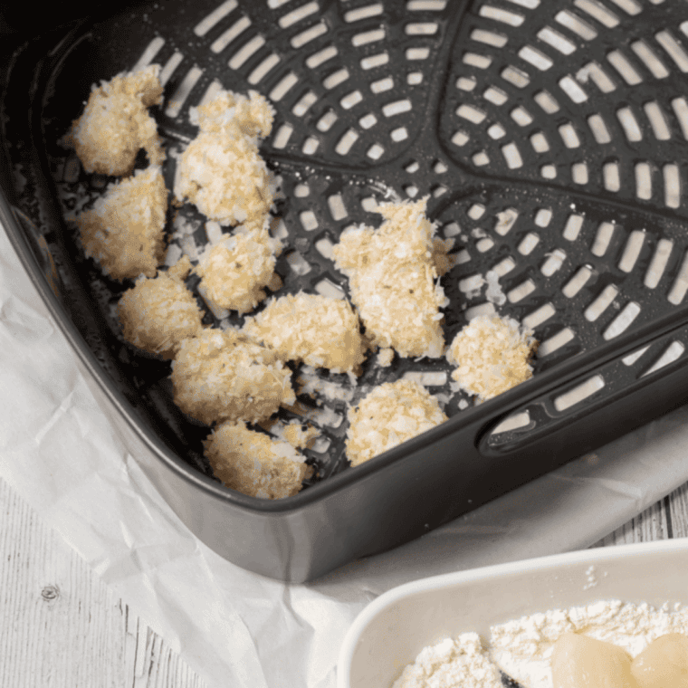 Coating scallops in flour, egg, and crushed Ritz crackers for even breading