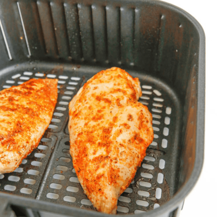 Instant-read thermometer checking air fryer thin chicken breast at 165&deg;F
