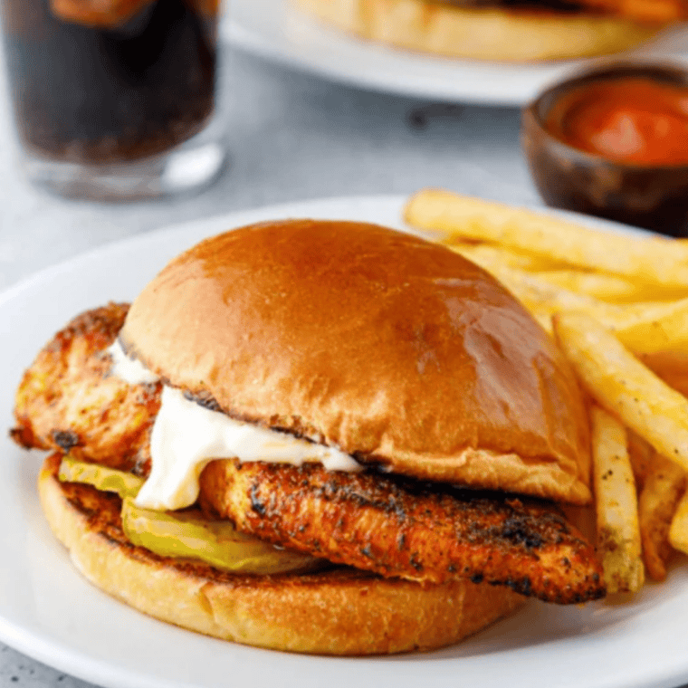 Cooked air fryer thin chicken breast sliced against the grain to show the juicy interior