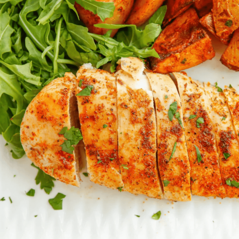 Golden air fryer thin chicken breast fresh from the basket, juicy and fully cooked